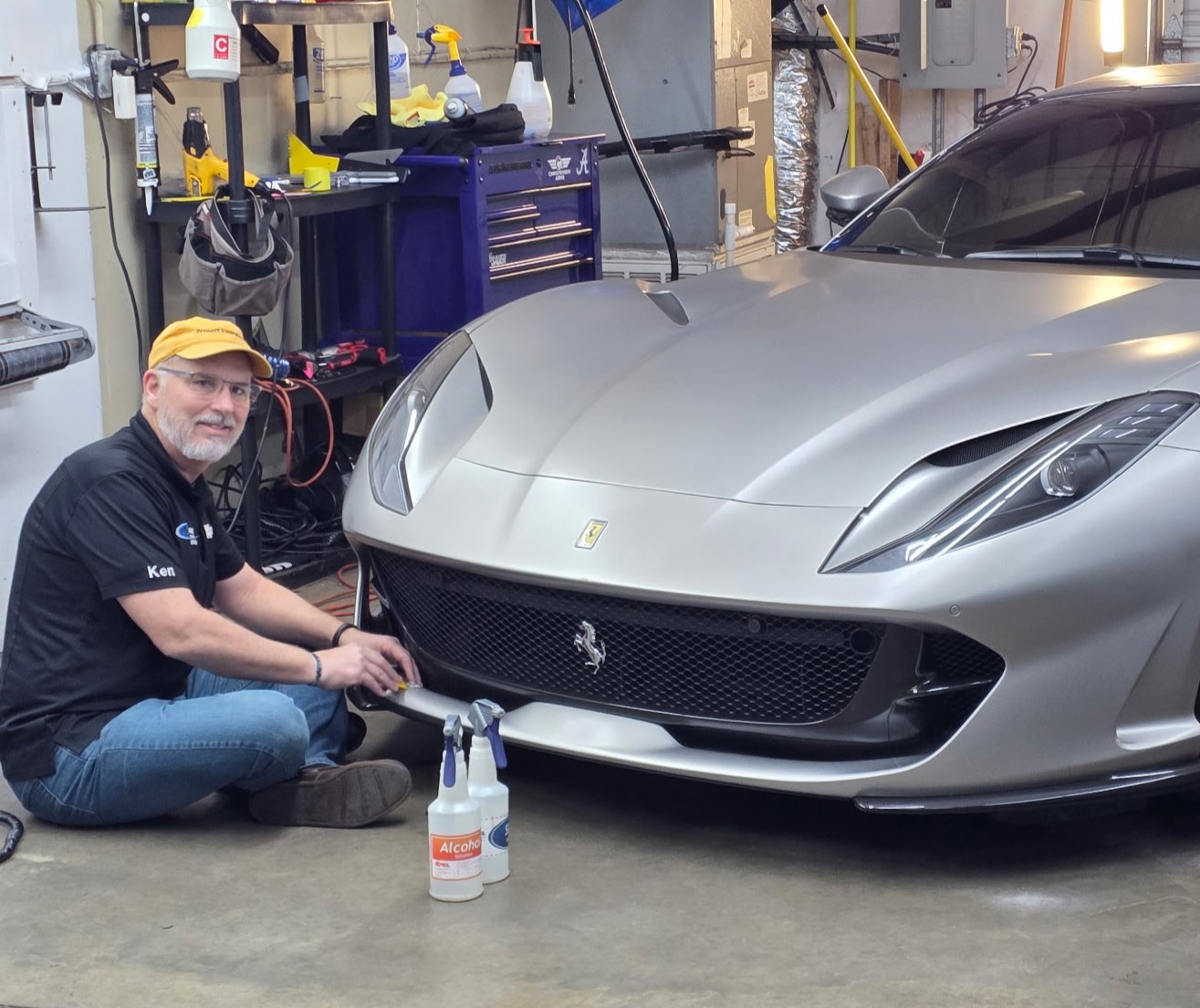 Paint Defender owner Ken Stommel installing XPEL Stealth paint protection film on the factory satin bumper of a 2021 Ferrari 812 GTS.