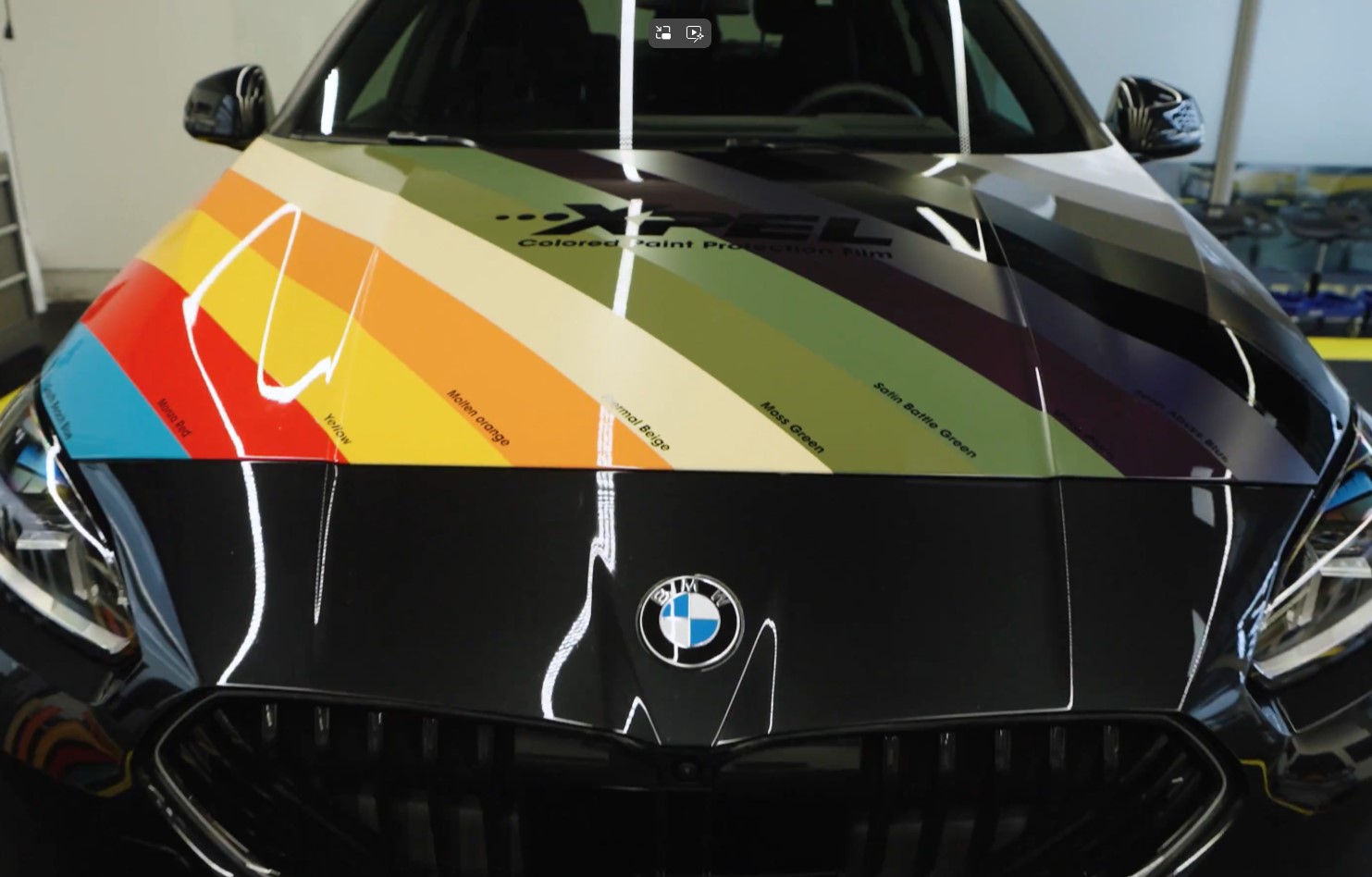 BMW hood showcasing stripes of XPEL Colored Paint Protection Film (PPF) to demonstrate glossy color change options and rock chip protection.